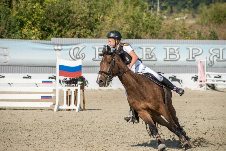 a woman is riding a horse in an arena