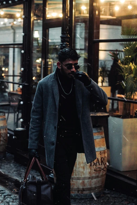 a man walking on the street while talking on his phone