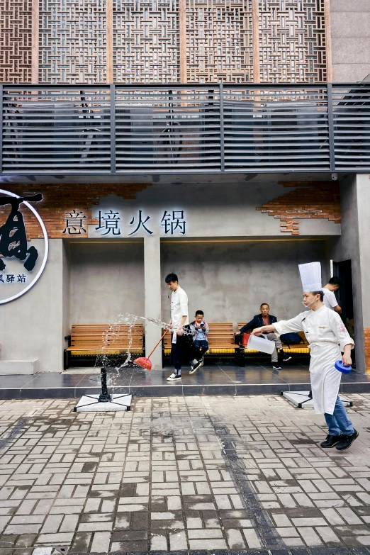 three chefs are in uniform outside of an asian restaurant