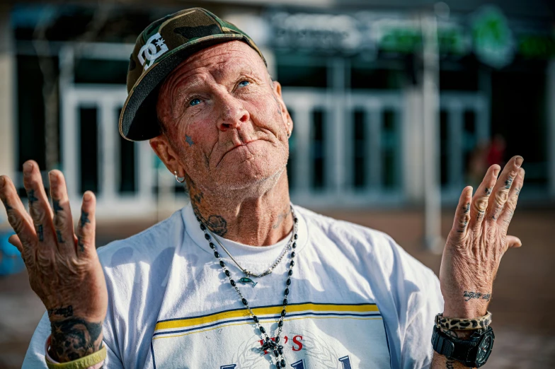 an old man with his hands crossed, in front of him