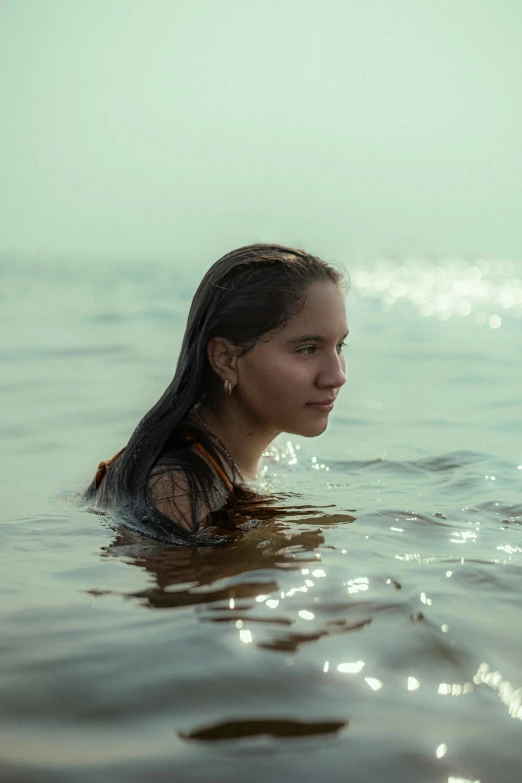 woman floating in the ocean on a sunny day