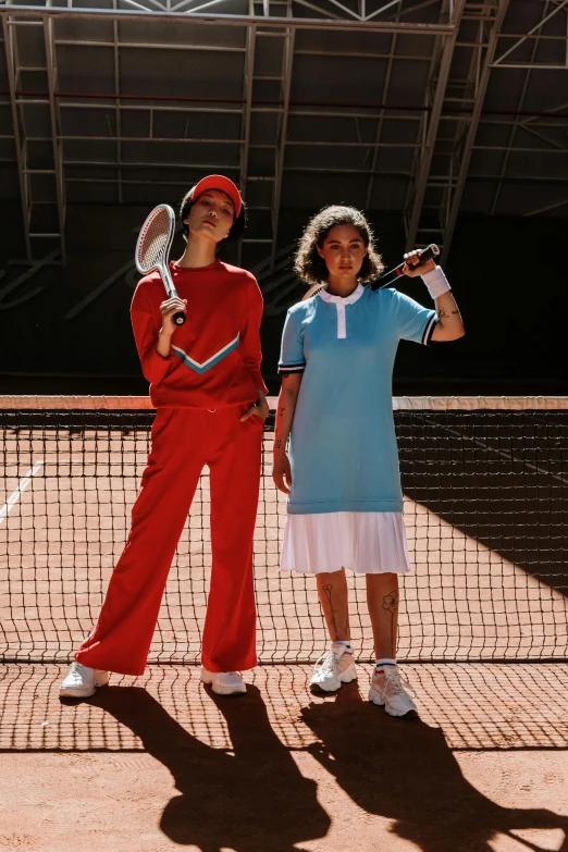 two s on tennis court posing for picture