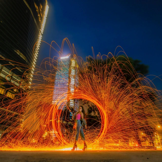 people walking on the ground with a tunnel of fire