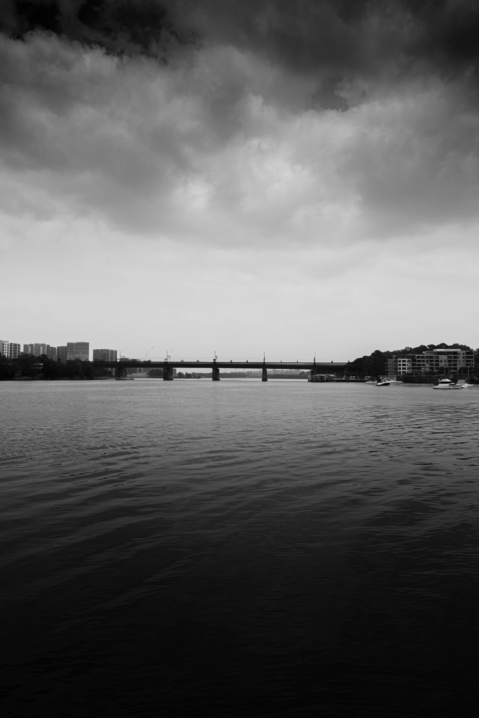 view of a large body of water with bridge in background