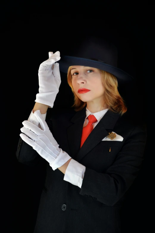 a woman in a top hat holding a glove