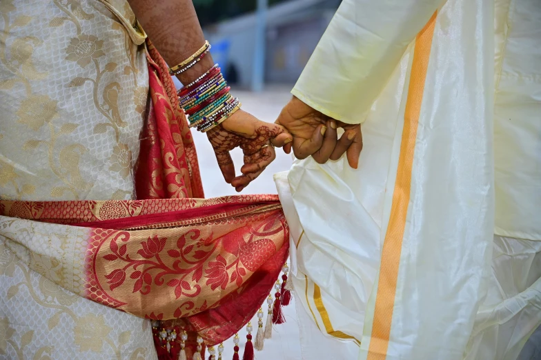 a man holding the hand of a womens arm