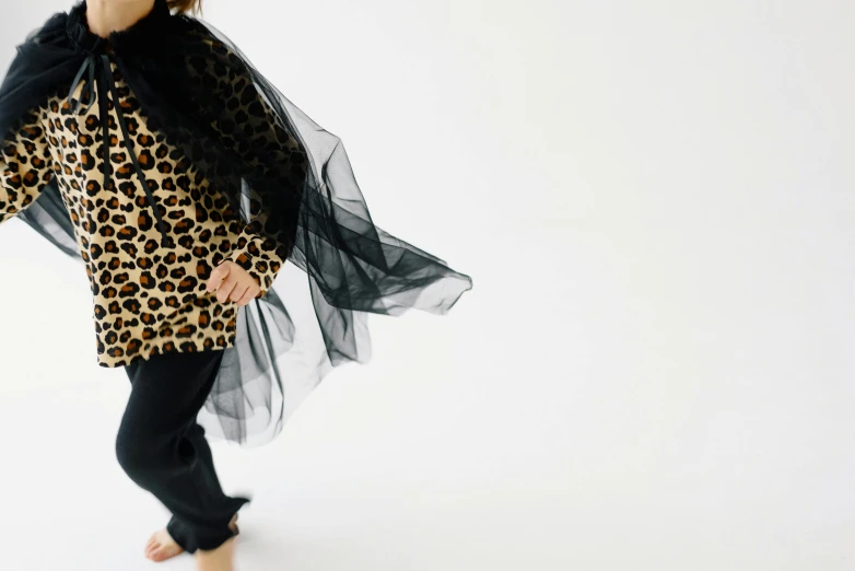 woman in animal print blouse with sheer veil