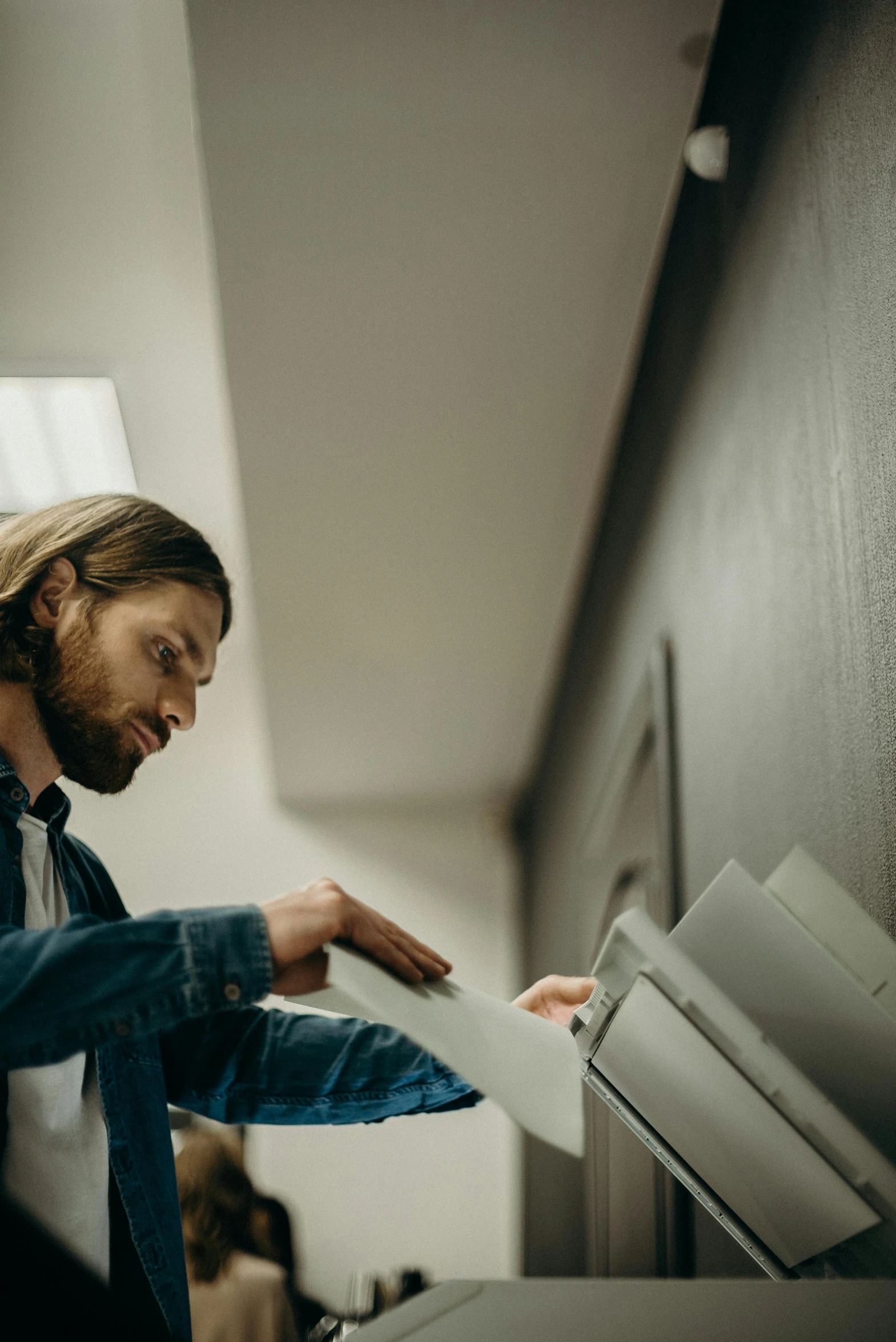 a man is holding a package of paperwork