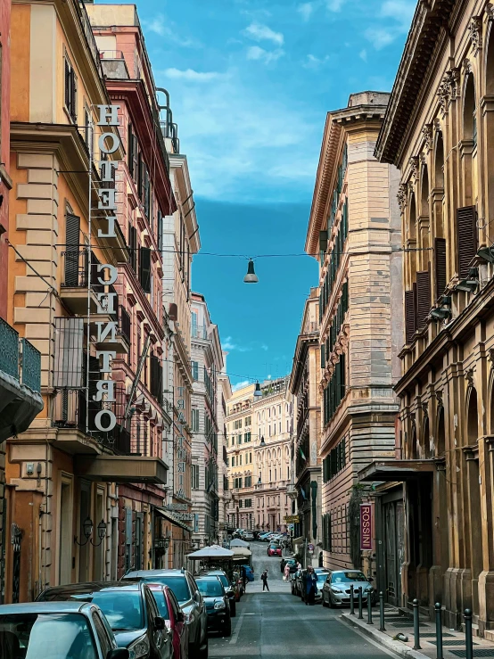 an empty city street is lined with tall buildings