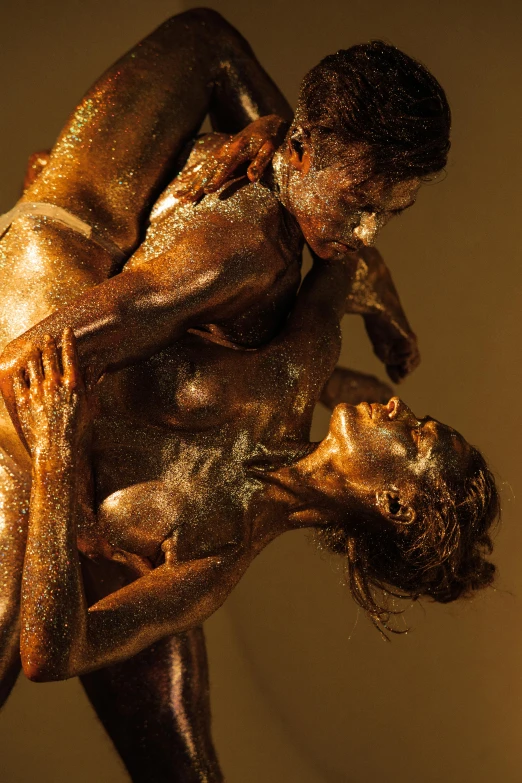 the bronze figure is hugging in front of a mirror