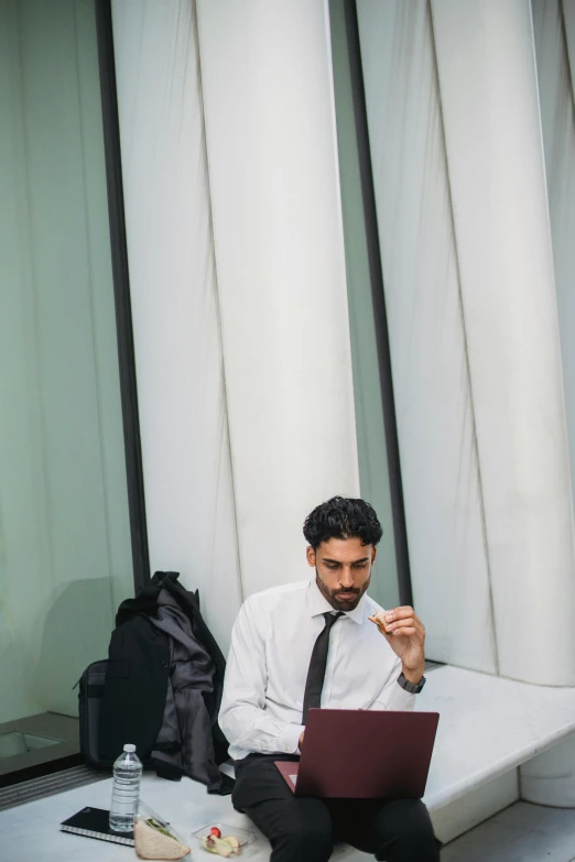 a man sitting on some steps with his laptop