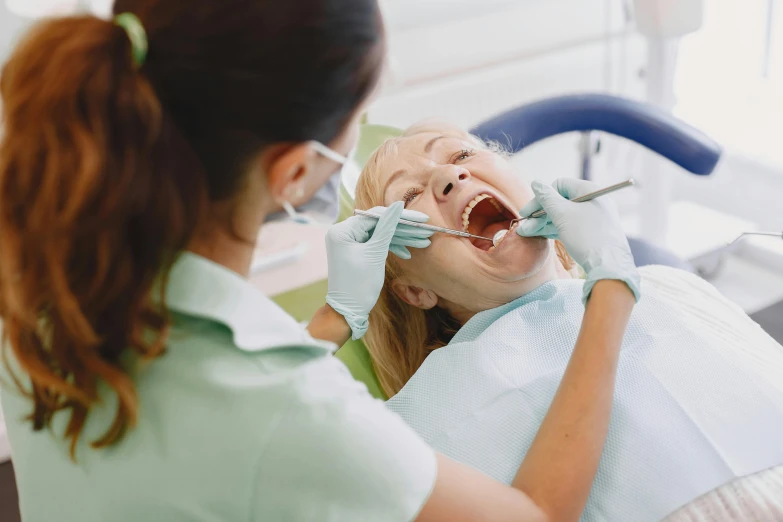 a young woman in the dentist talking to a girl