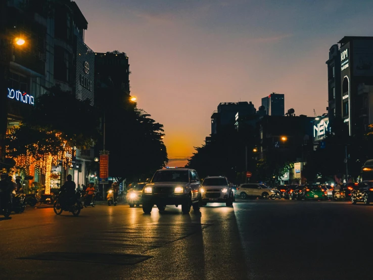 several vehicles are on the road at night