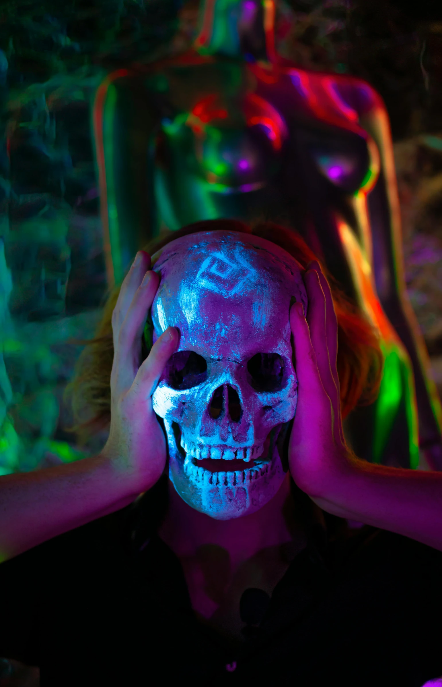 a woman holding her head over her face while standing in front of a neon - colored artwork