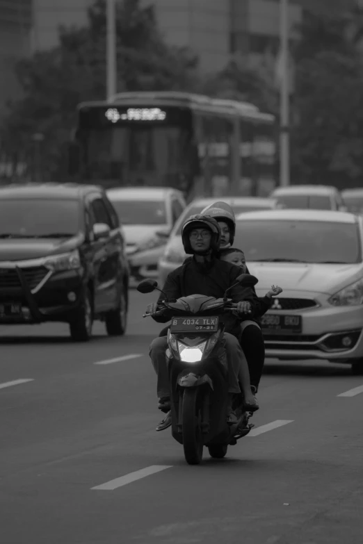 a man is driving his motorcycle in the street