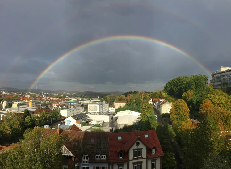 a rainbow and a dark sky in the distance