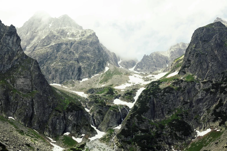 mountain peaks in clouds and snow are seen