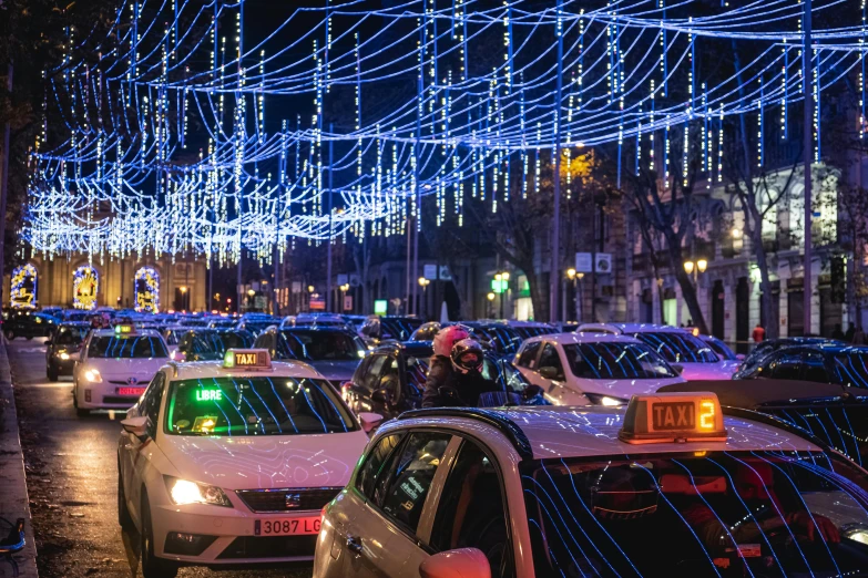 a busy street with lights strung above