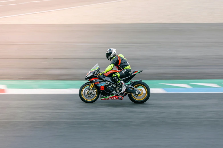 a motorcyclist races on the asphalt road