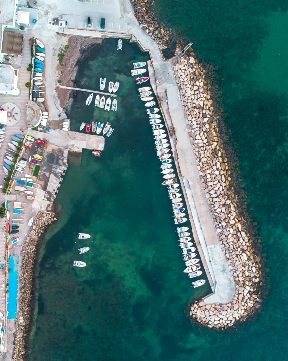 a harbor filled with boats next to the ocean