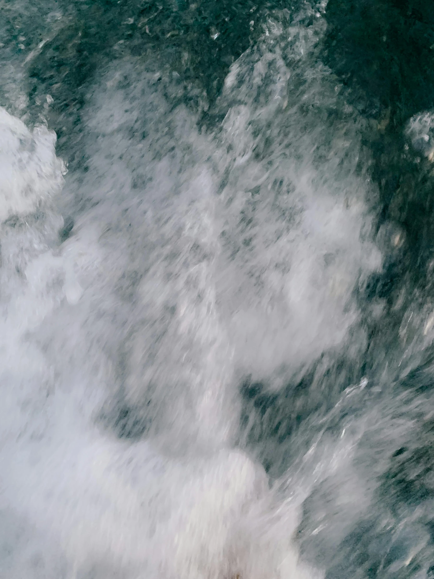 a large body of water next to clouds