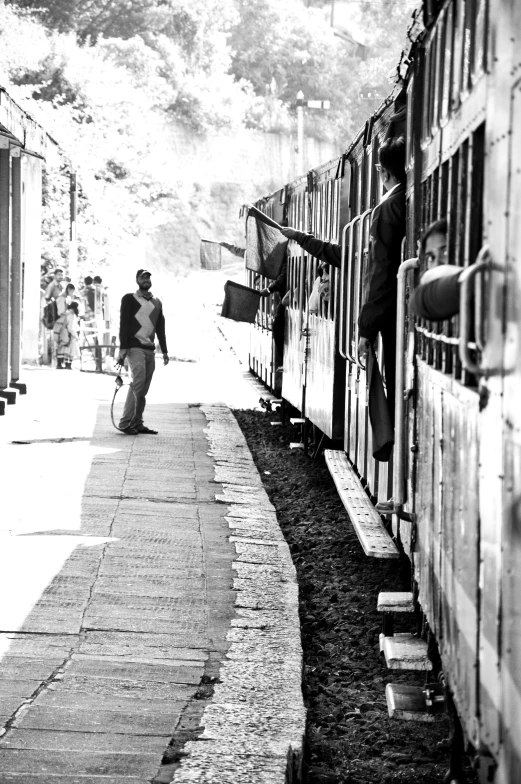 a black and white po of a train traveling down a track