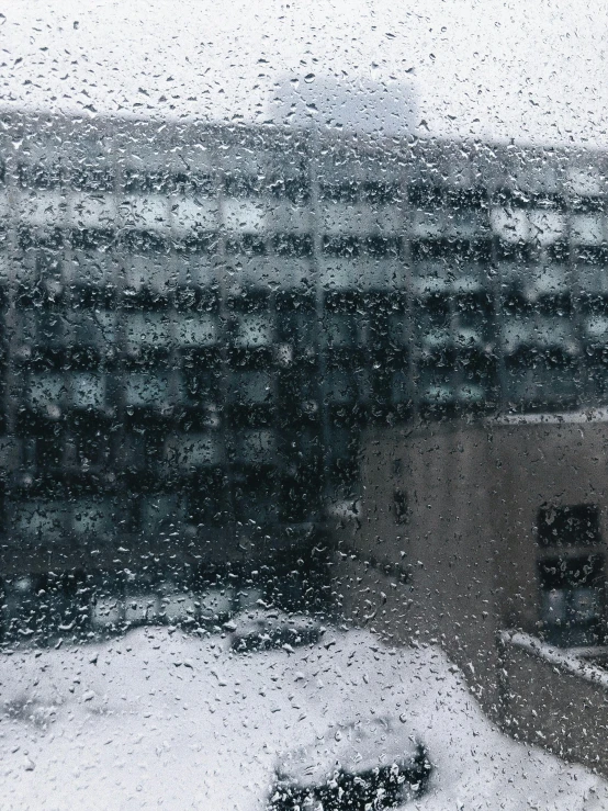 a window with snow outside and a window view with cars