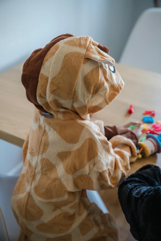 a stuffed animal doll sitting on top of a table