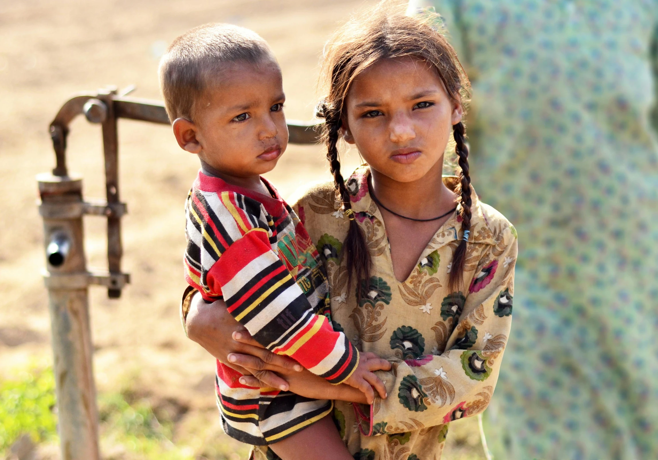 two children that are standing next to each other