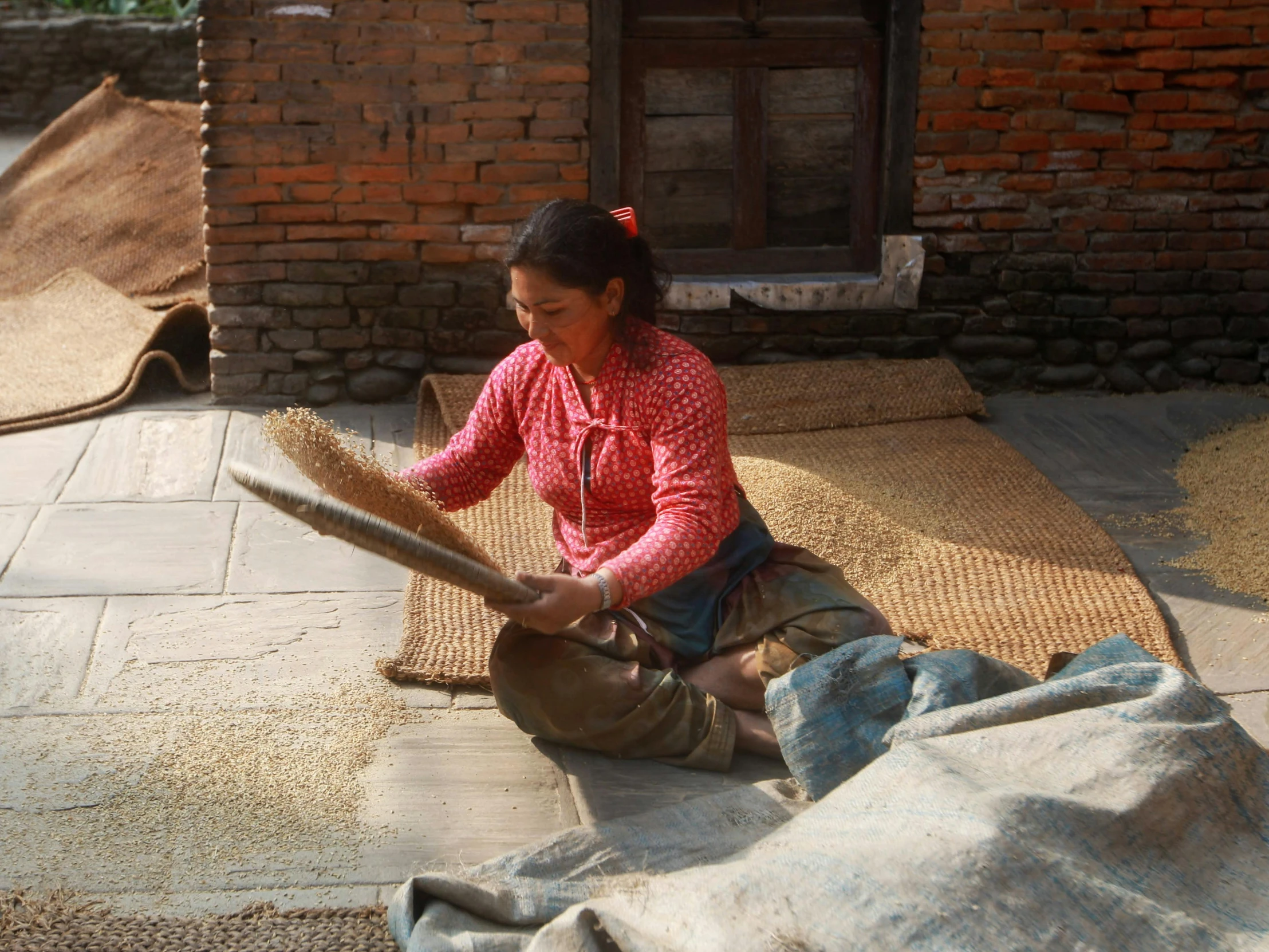 the little girl is using the wheel for making a vase