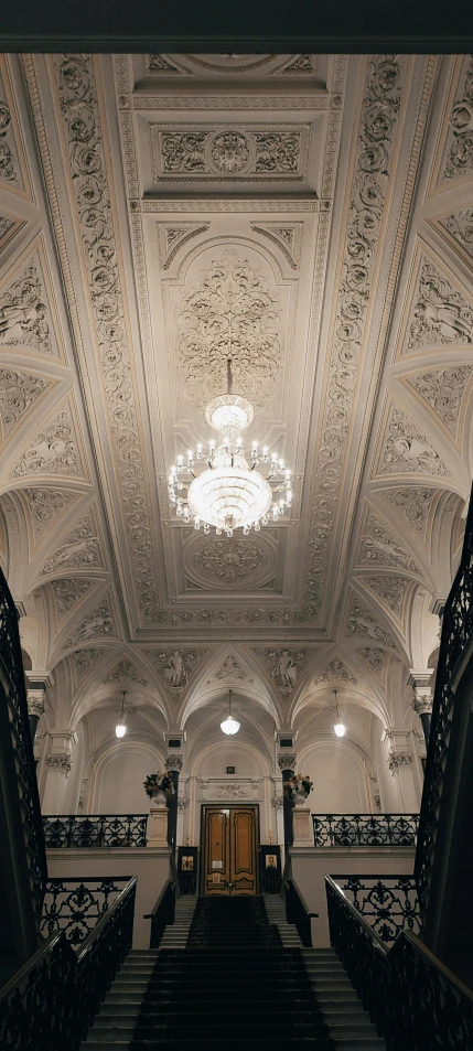 a grand stairway in an elegant building with lights