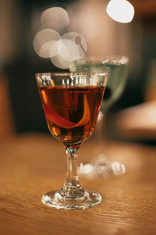 a glass on the table of a very nice looking drink