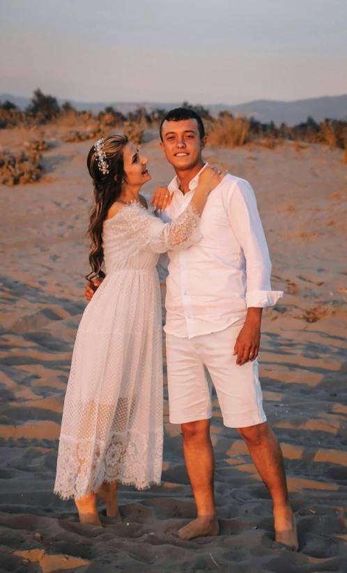 two people in a field wearing white