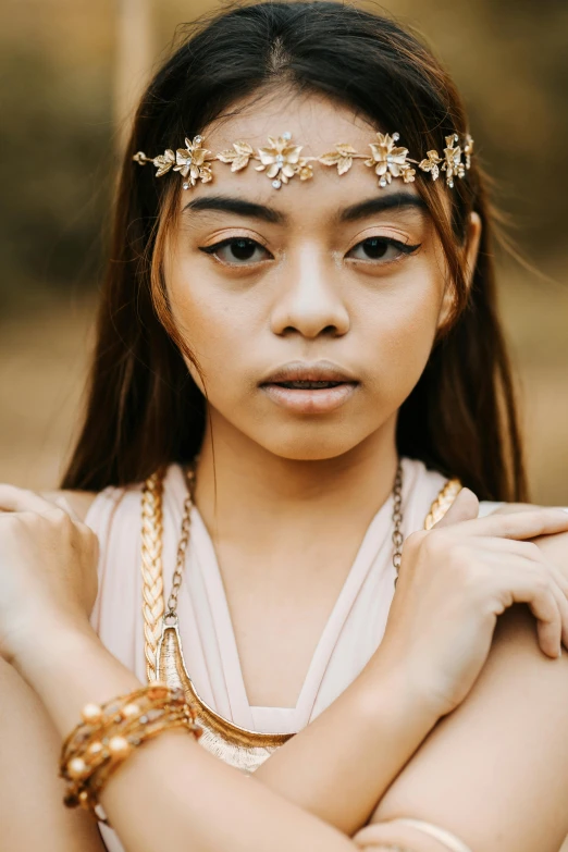 a woman with a bunch of celets and a hair piece