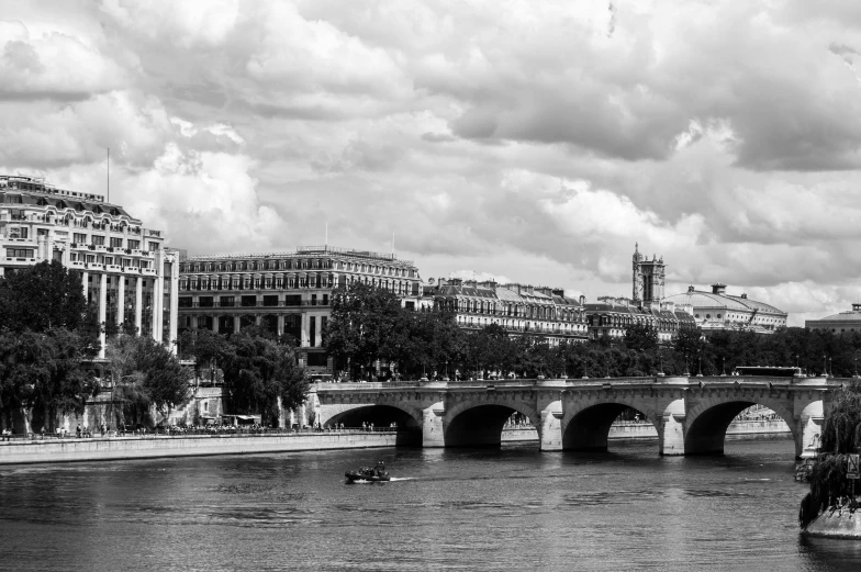 a beautiful river with boats on it and tall buildings in the background