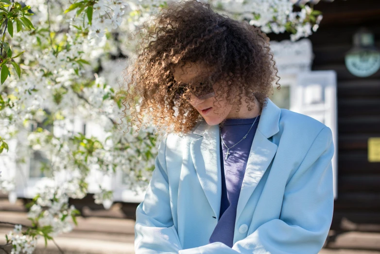 a woman standing outside looking at her phone