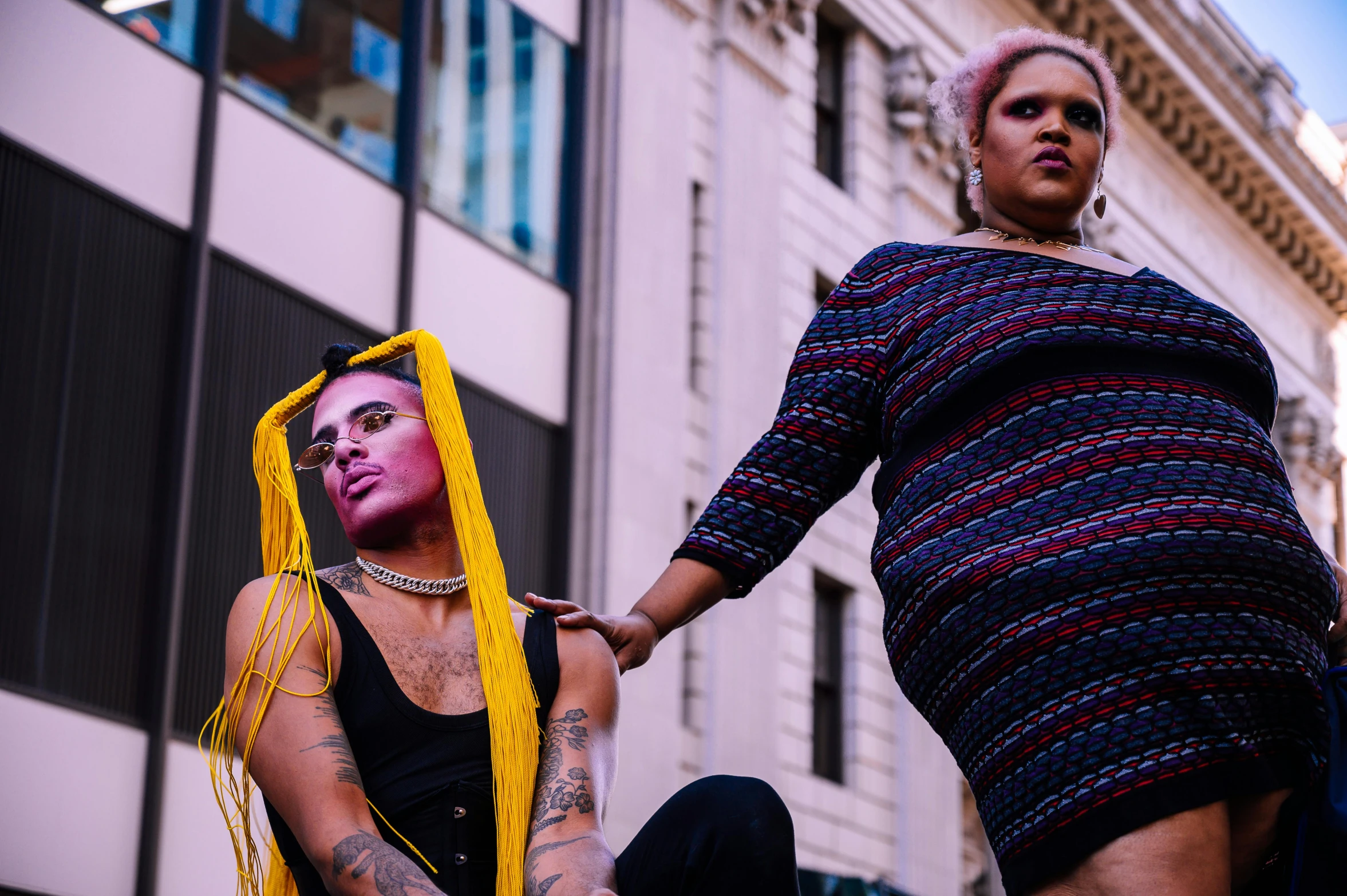 two women wearing costumes and some very colorful makeup