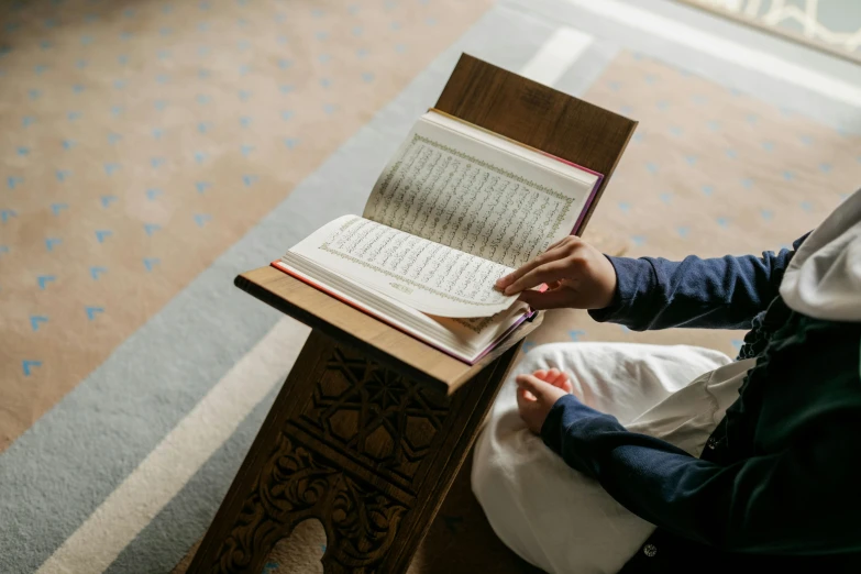 a person with a book and pen and an open bible