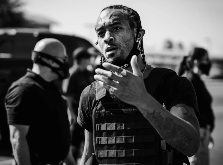 a man in front of some police standing on the street