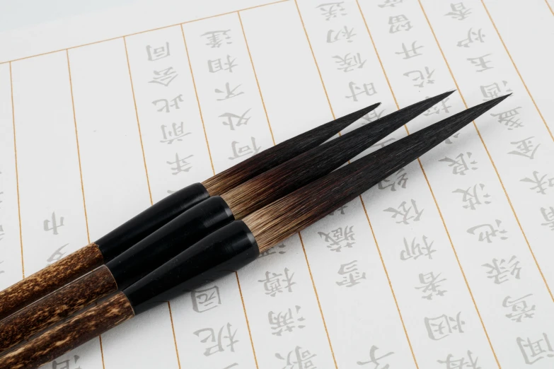 four wood tips sitting on top of paper with japanese writing on it