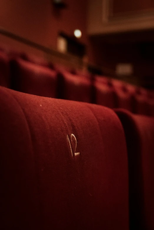 a red theater seats with the initials f