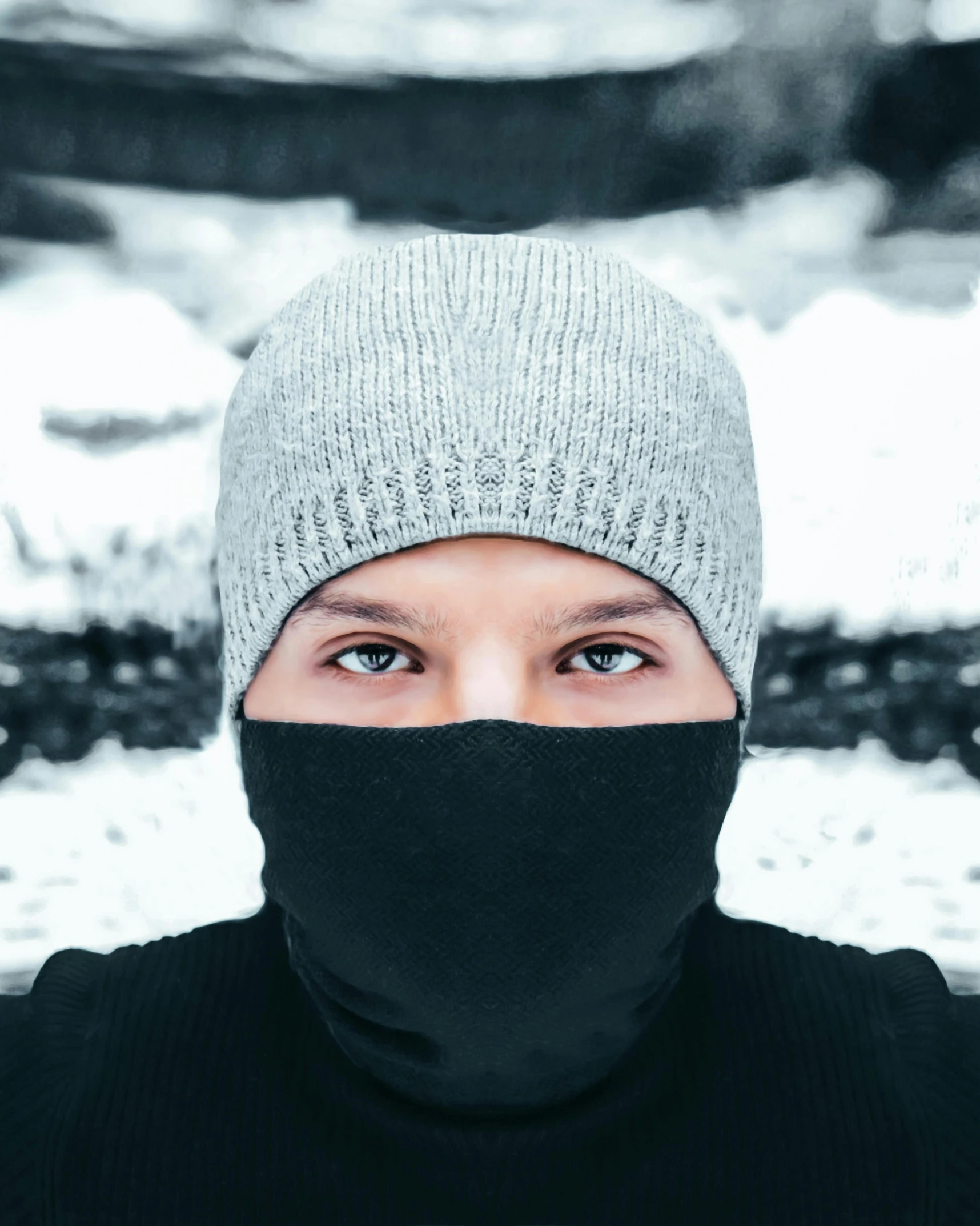 a person with a hat covering his face with black mask