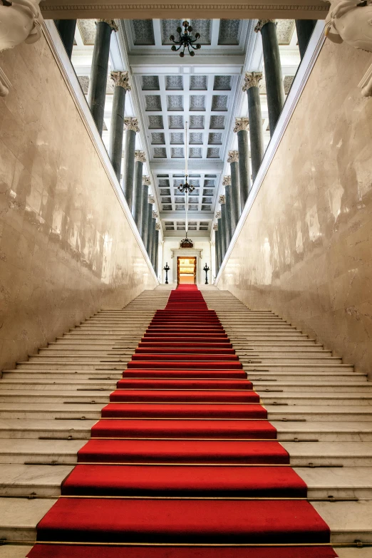 an ornately decorated aisle leading to red carpeted stairs