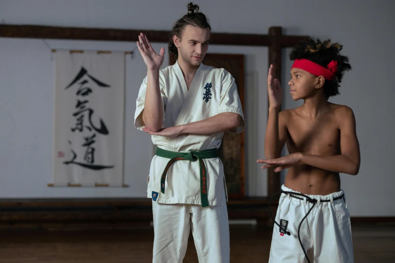 a person standing next to a man with karate uniform on