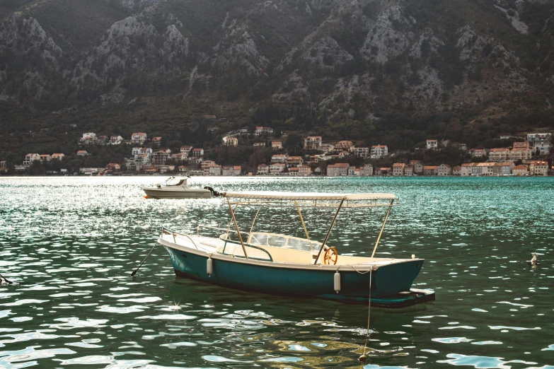 two boats floating in water next to a city