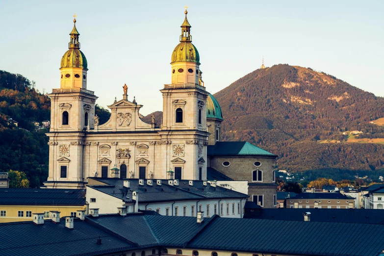 the city skyline shows mountains behind the church