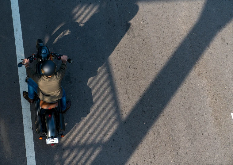 a person riding a motorcycle next to a building