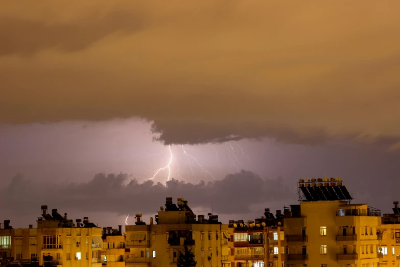 a bunch of buildings that have lightning above them