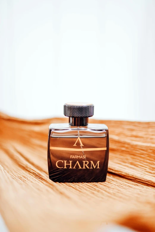 perfume bottle on brown wood floor with white background