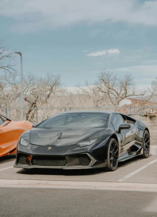 the exotic cars are parked in the lot